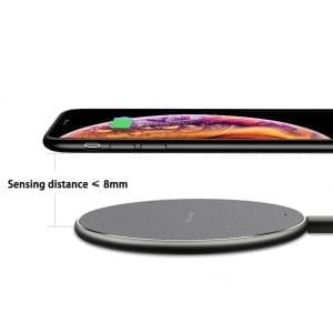 Wireless charging pad with smartphone showing charging icon, labeled sensing distance < 8mm.